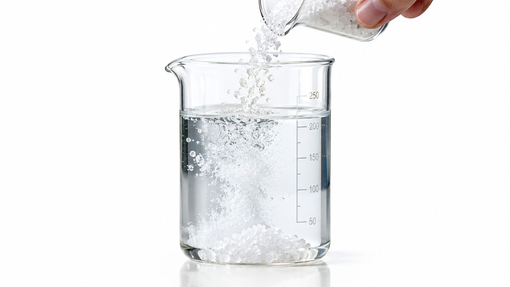 A laboratory beaker containing water where white crystals are being poured in from a small flask.