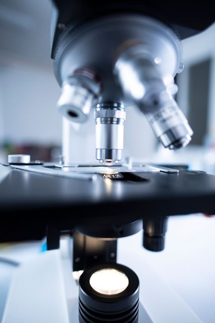 Lab Best Practices.Detailed view of a laboratory microscope focusing on lens and optical components.